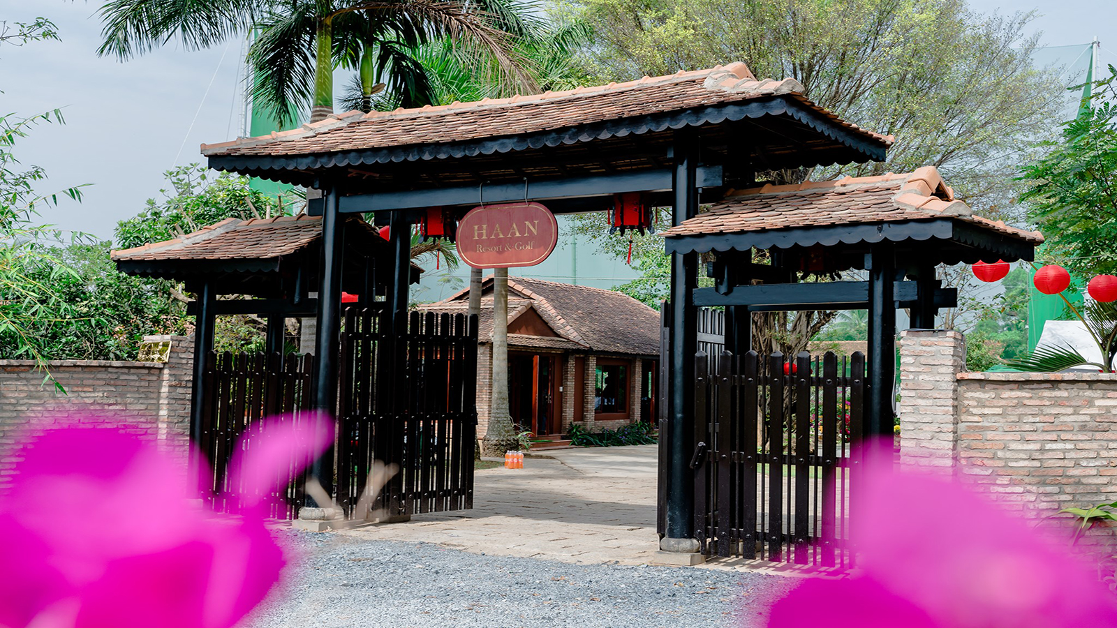 Cổng vào Haan Boutique Resort & Golf thiết kế theo lối kiến trúc truyền thống với mái ngói và đèn lồng đỏ.